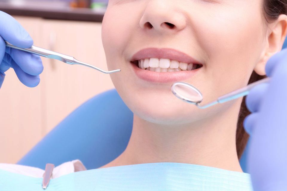 Smiling woman with dental instruments